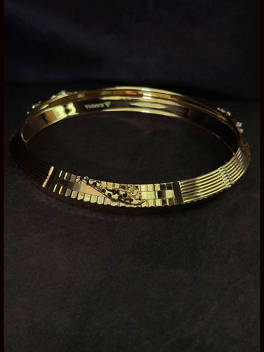 Rhodium and gold plated men's kada with jaguar design on one side and dotted rhodium design on other