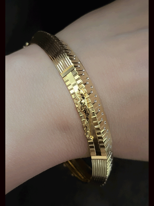 Rhodium and gold plated men's kada with jaguar design on one side and dotted rhodium design on other