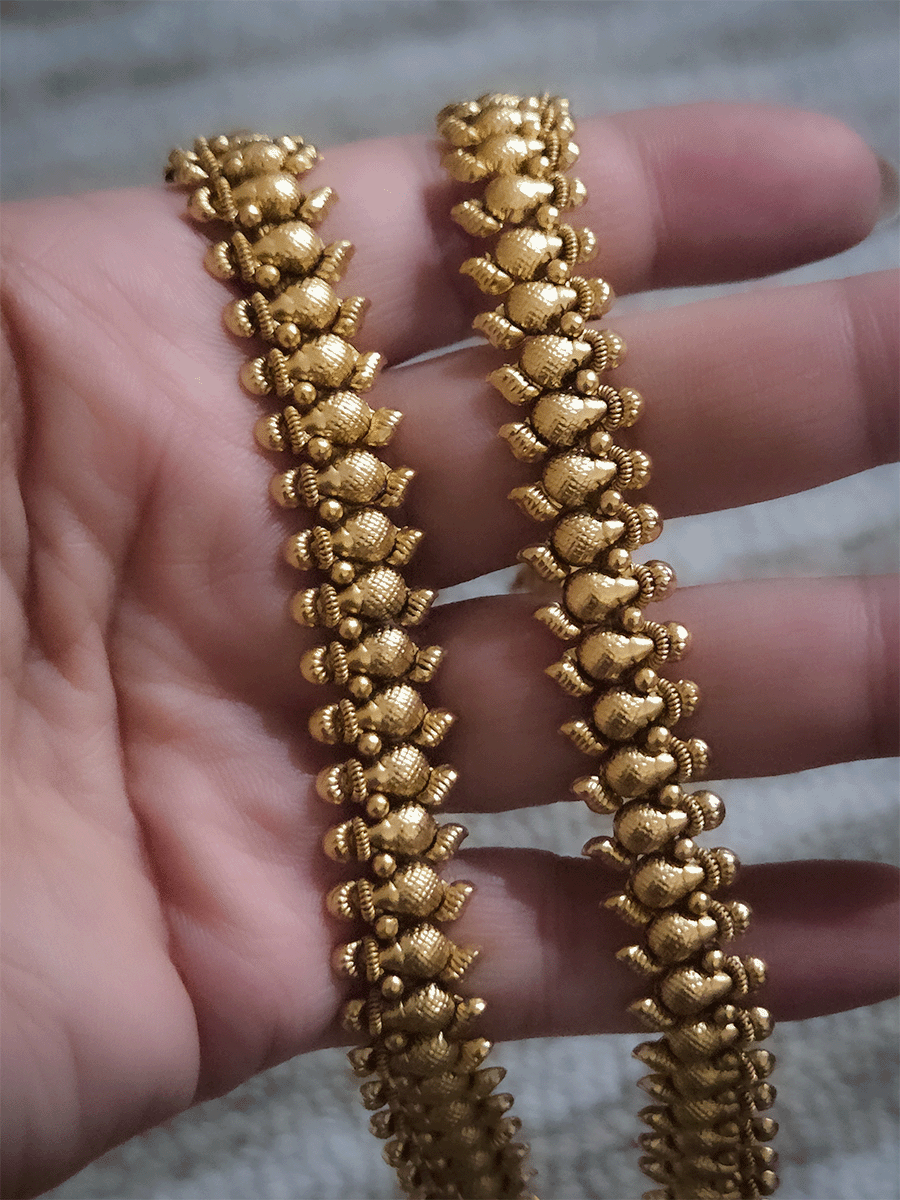 Gold bead top with leaf attached at the bottom of leaf shaped gold bead chain anklets