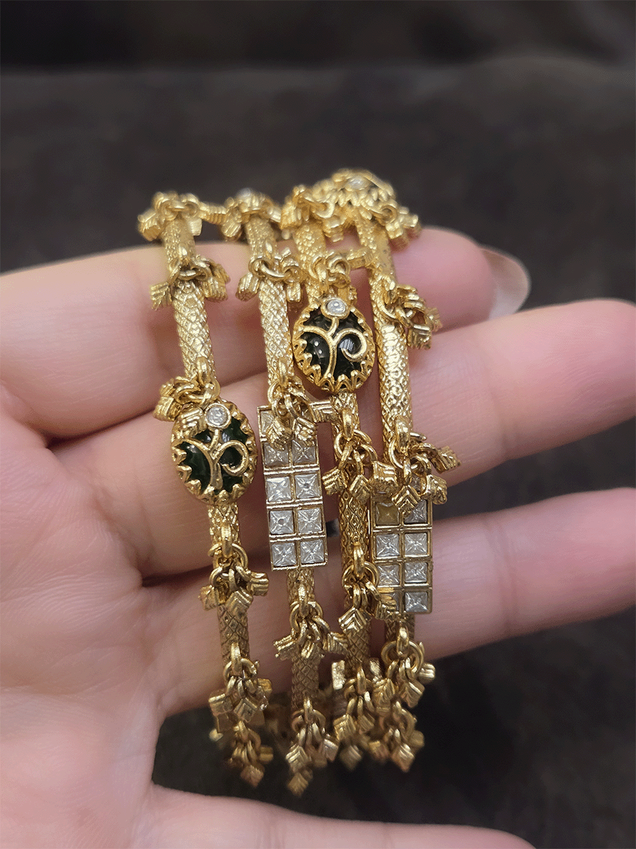 Set of four non-openable ghunghru hanging bangles with inlay work on oval green stone