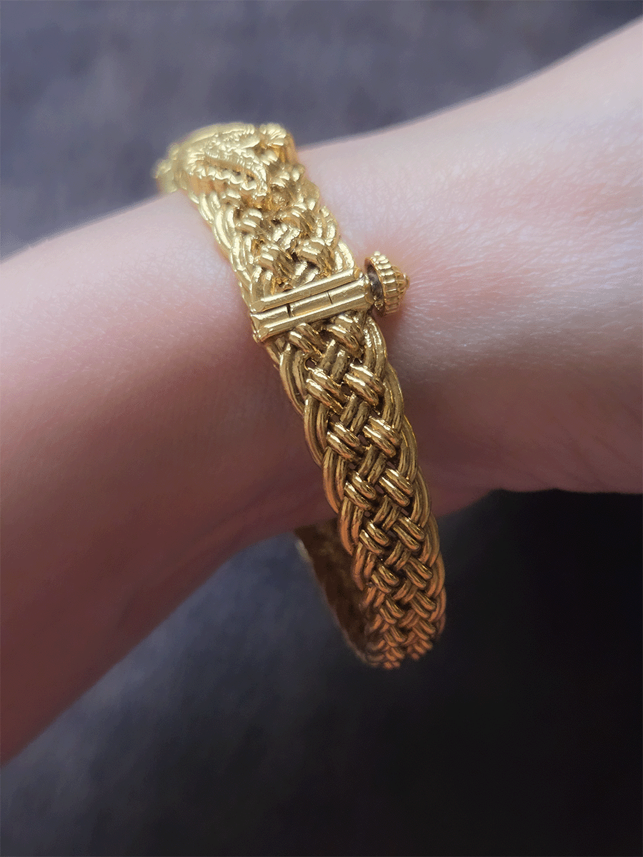 Single openable braid design kada with oval ruby stone center and peacock design on sides