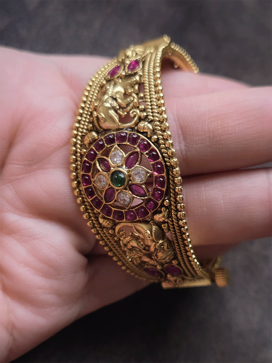 Single openable kada with polki,ruby and green stone circular design in center with elephants on both sides