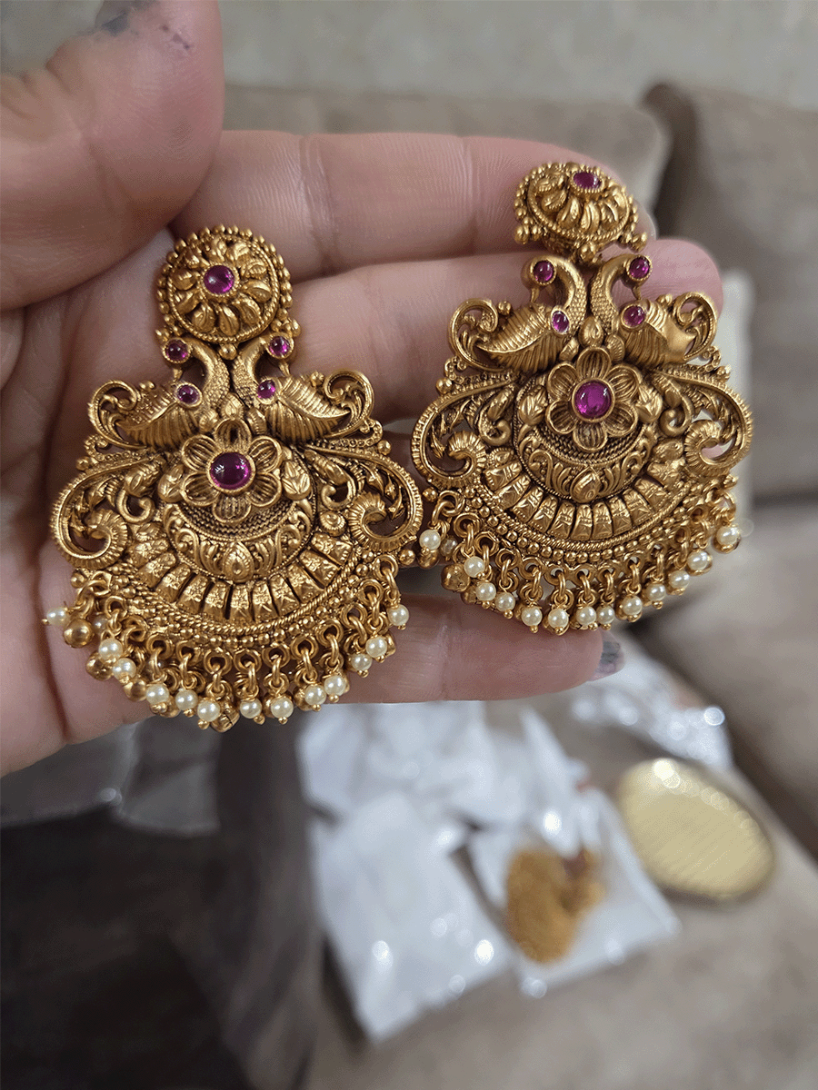 Circular ruby stone top with peacock and flower design earrings with pearly hangings