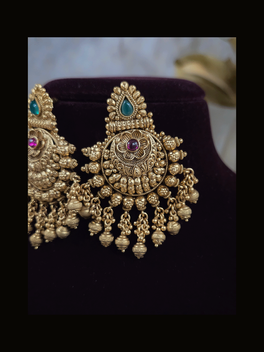 Green tear drop leaf design top with ruby stone flower and flower engraved gold bead design earrings