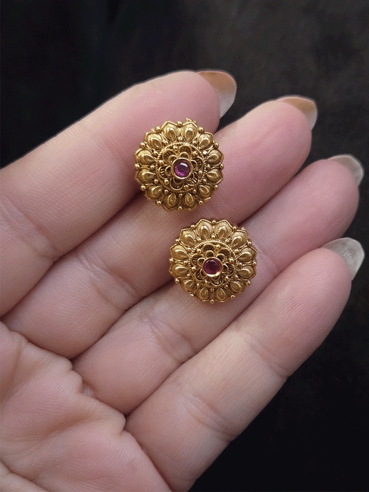 Ruby stone in the center of flower design studs with leaf petal design
