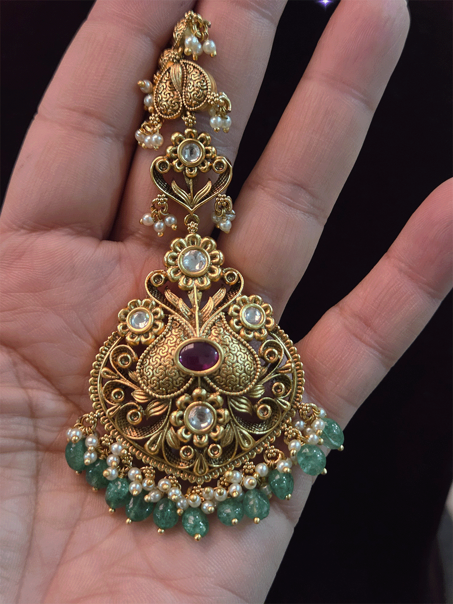 Oval ruby stone kundan studded maangtika with green bead hangings