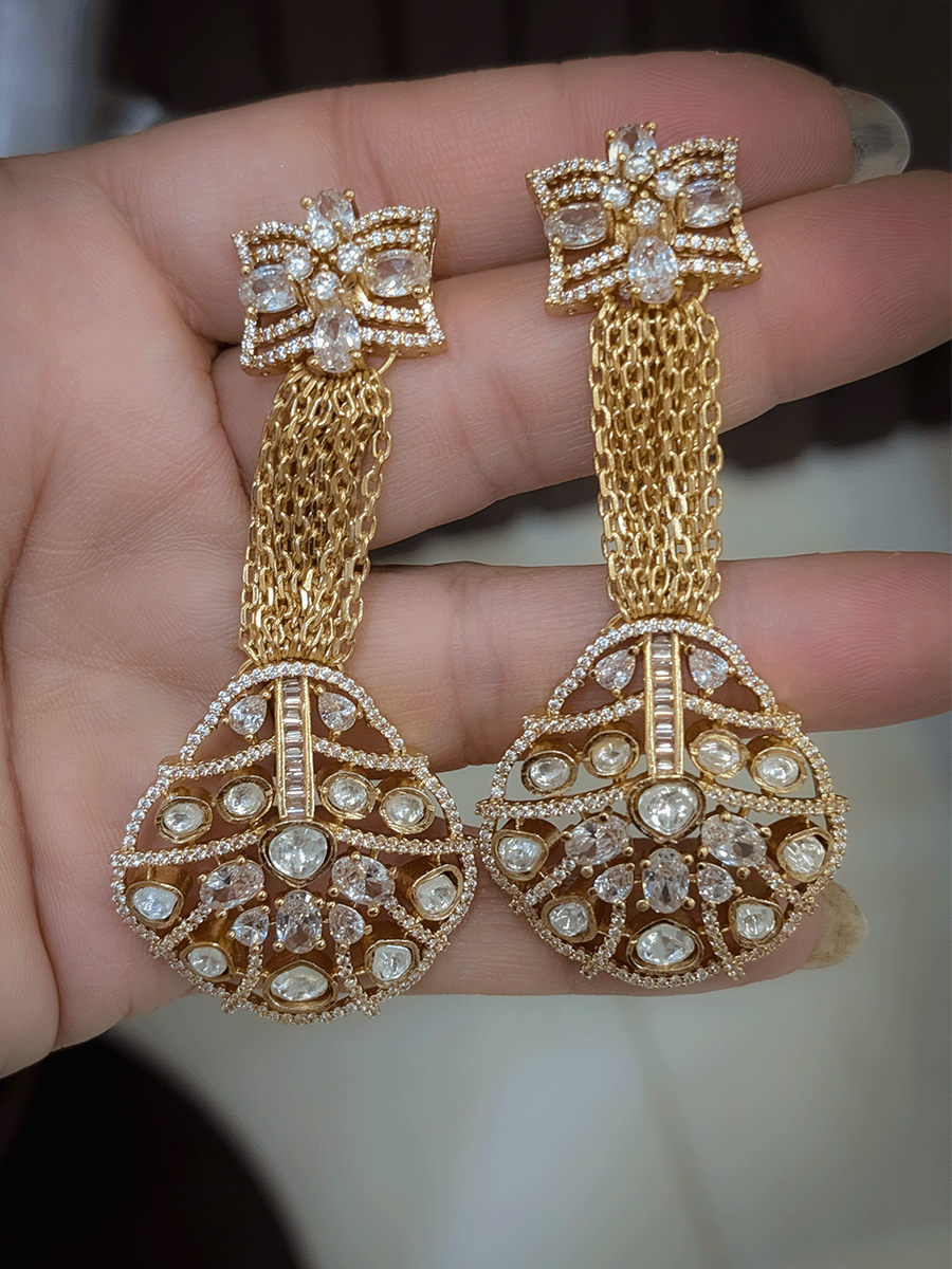 Multiple gold chains set with long moissanite pendant and tukdies on sides