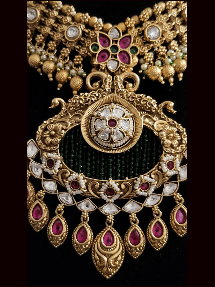 Peacock top kundan circular tukdi green bead detailing pendant set with leaf tukdi ruby stone drops