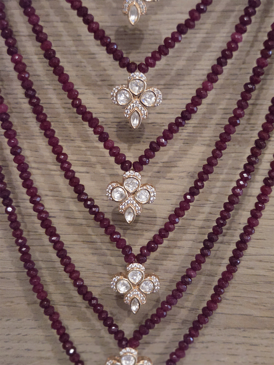 Seven layer onyx beads with half flower moissanite tukdies in center 17 inch long necklace