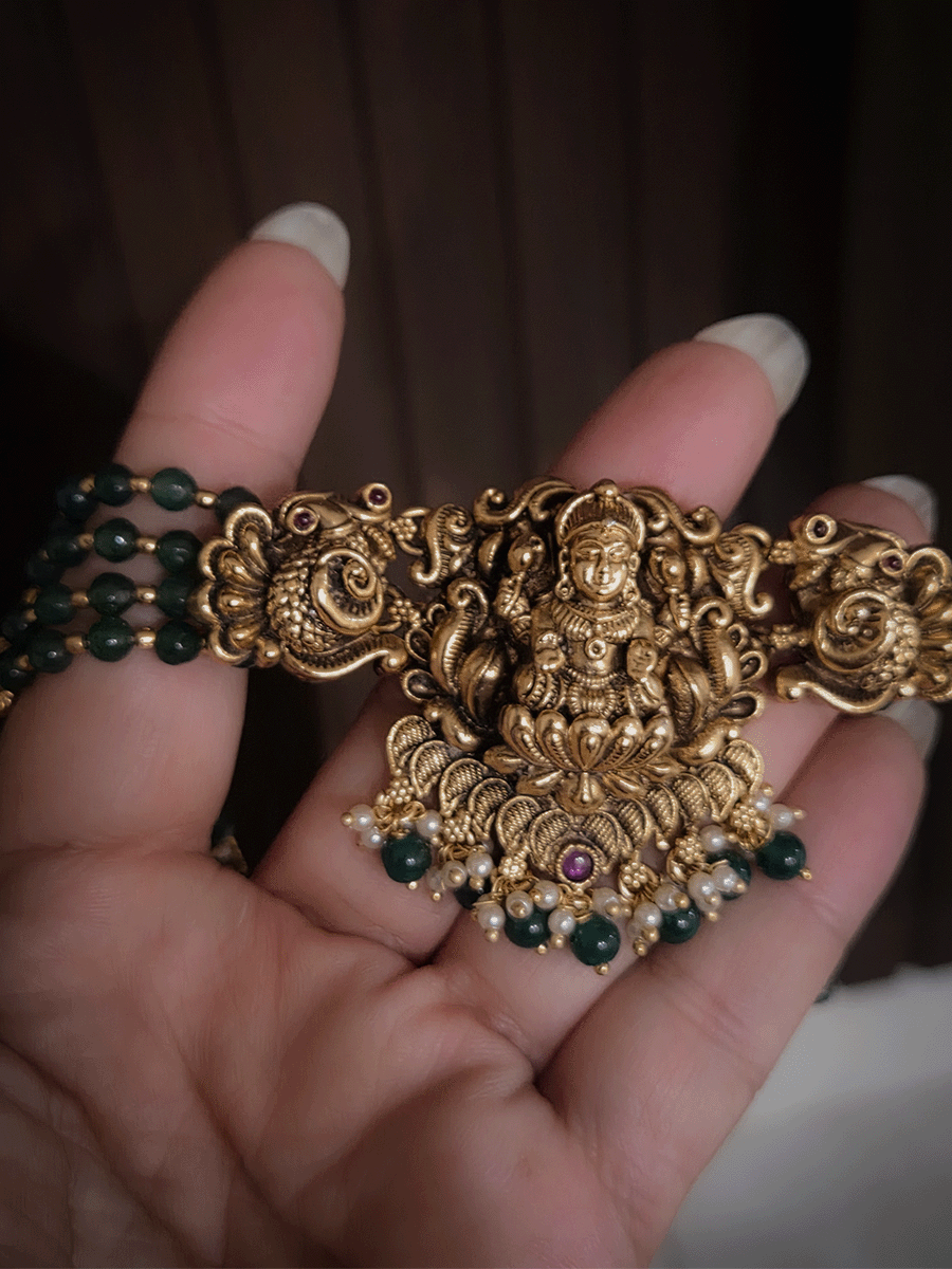 Laxmiji center with side peacock and green bead drops pendant in four green bead strings