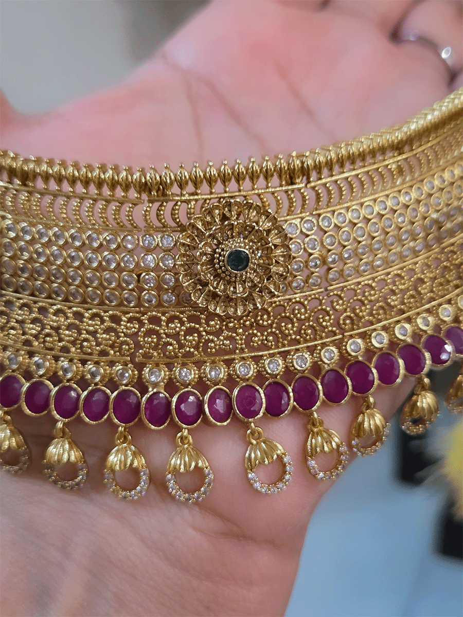 5cm broad flower center polki studded choker with oval ruby stones line and zircon loop hangings