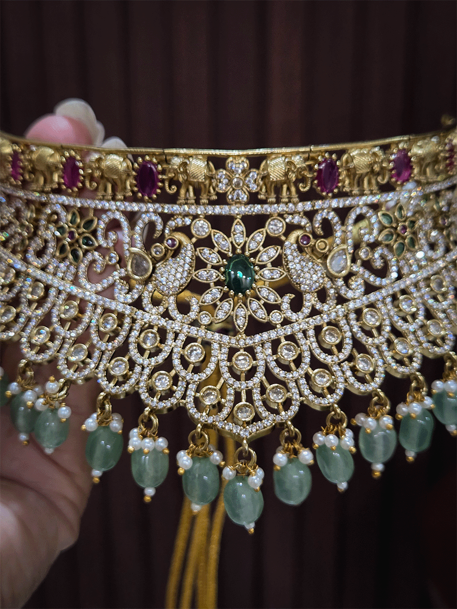Zircon studded peacock and elephant motif's broad choker set with coloured drops