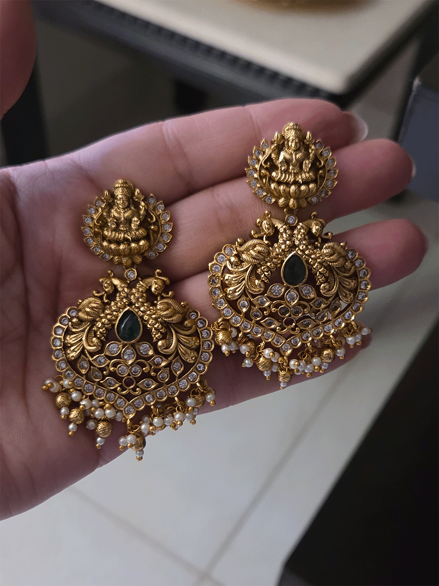 Polki and green stones studded Laxmiji center motif with peacock design set