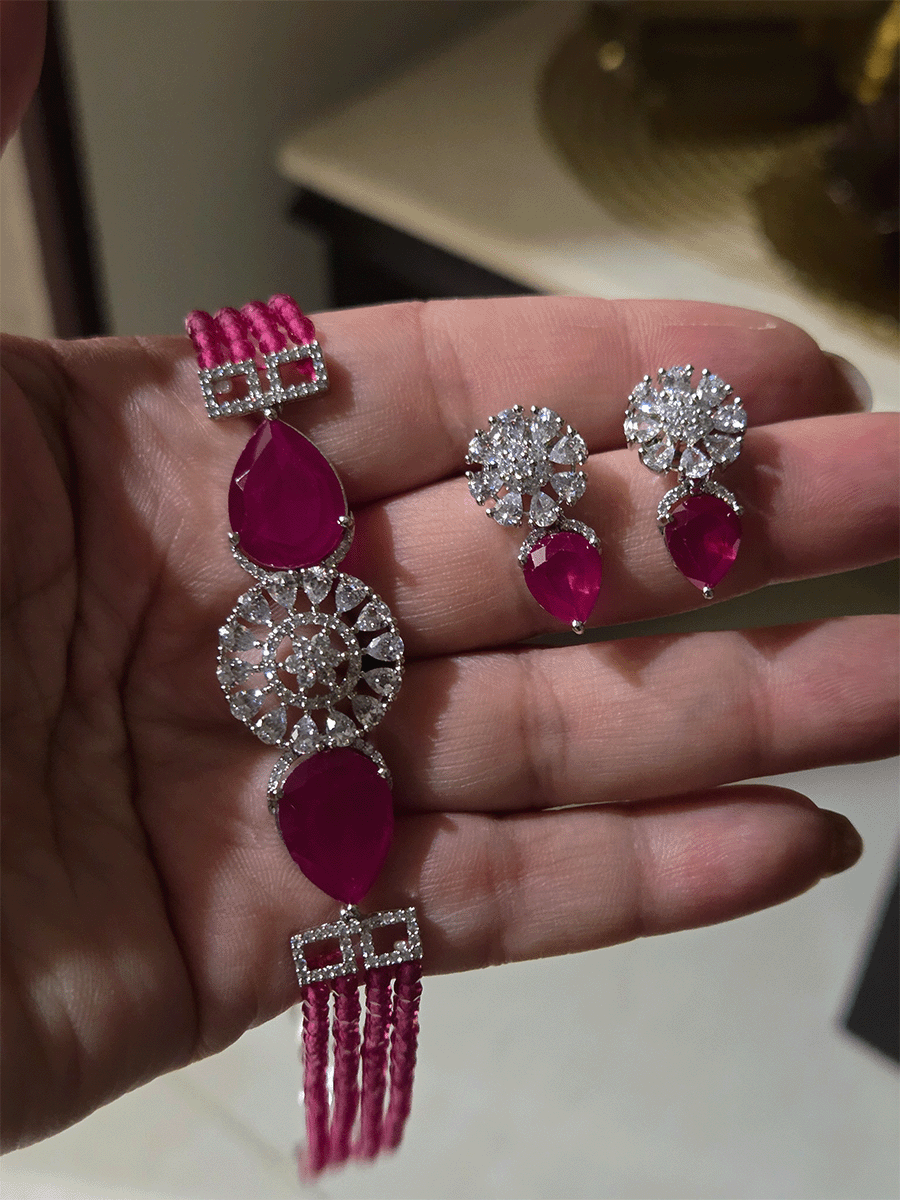 Circular center AD flower with side tear shaped stone and four onyx bead strings set