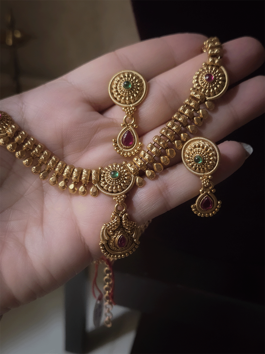 Circular tukdies with coloured stones sleek set with hanging tear drop shaped peacock tukdi in center