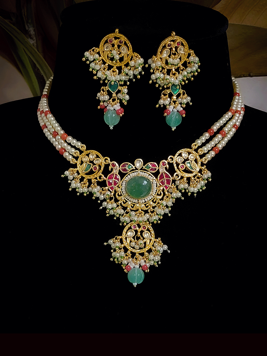 Aqua oval stone in the center with peacock side design aqua drops three pearl strings paachi kundan set
