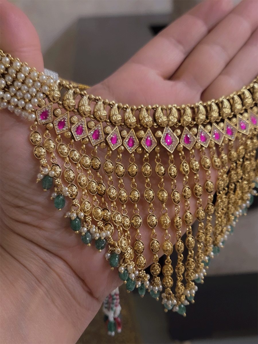 Golden tukdi tassels with green bead drops and paisley design top ruby stones set