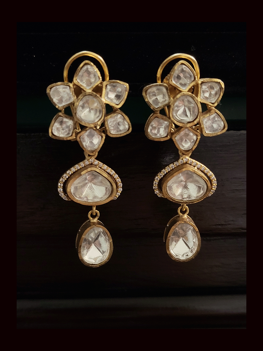 Uncut polki flower center with coloured triangular stone surrounded by AD drop set