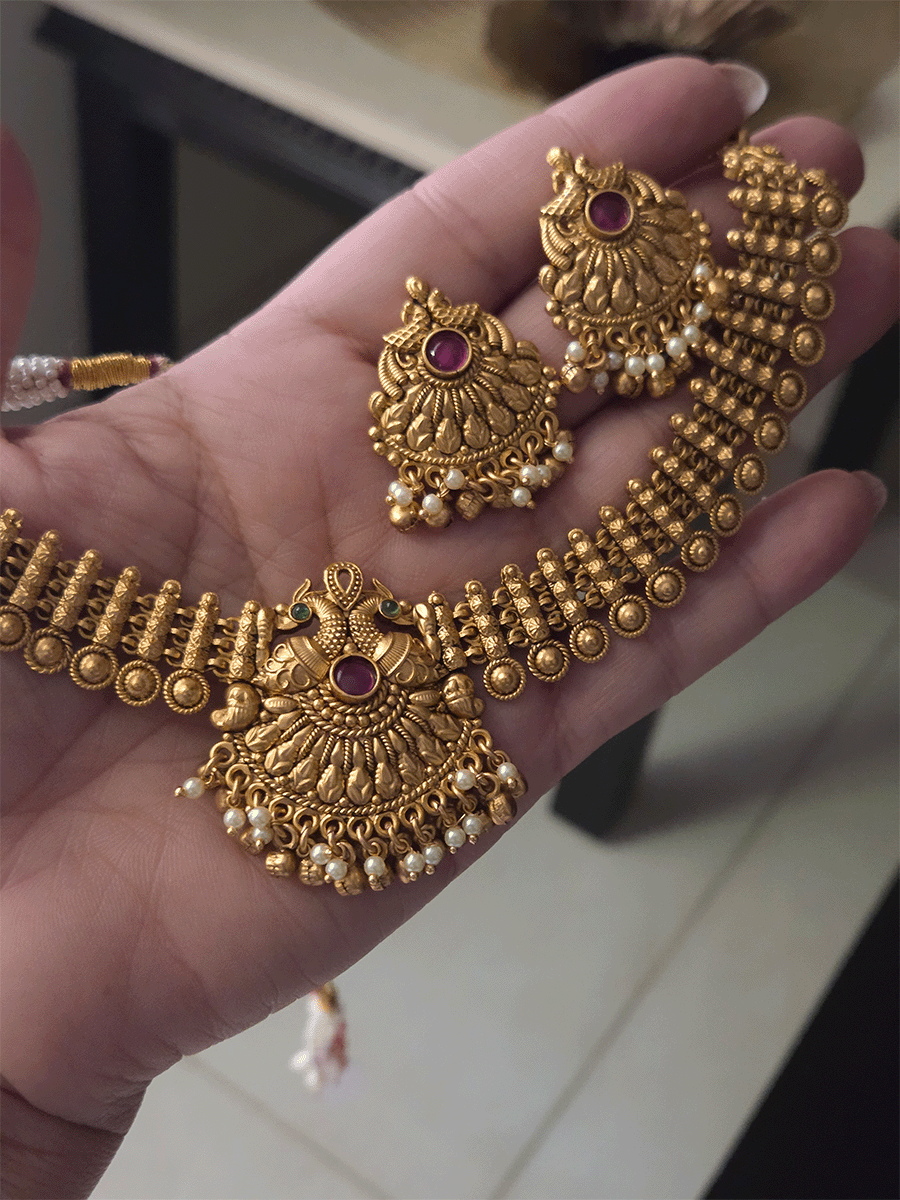 Broad chain with circular design with peacock design ruby,green stone center set