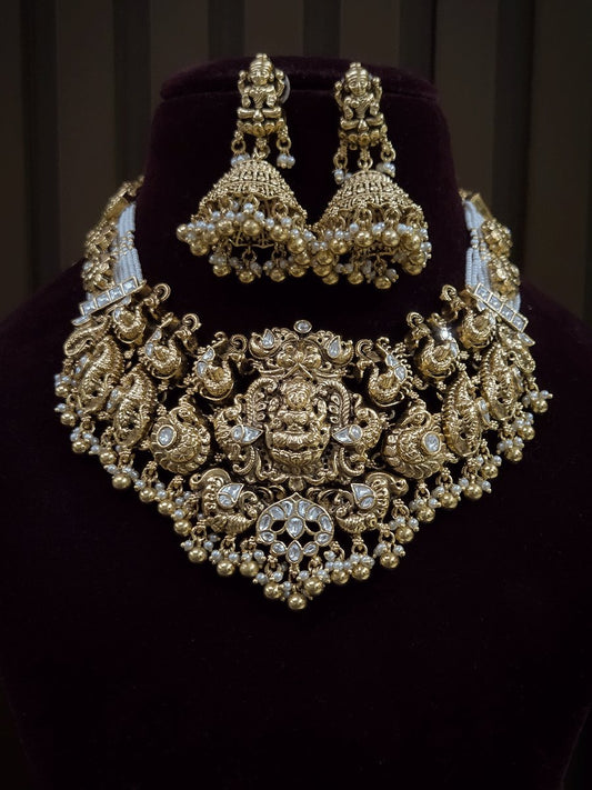 7 cm broad kundan studded laxmi ji choker set with intricately carved peacocks