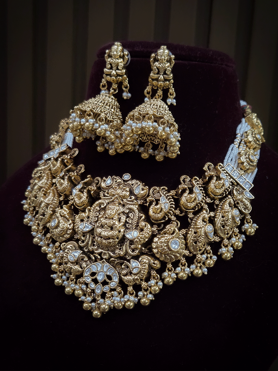 7 cm broad kundan studded laxmi ji choker set with intricately carved peacocks