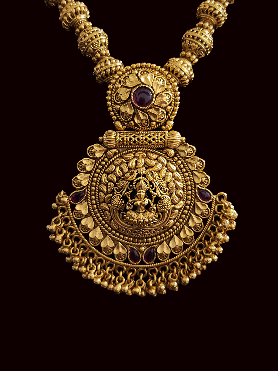 Circular top with ruby stone laxmiji pendant in matar bead string set