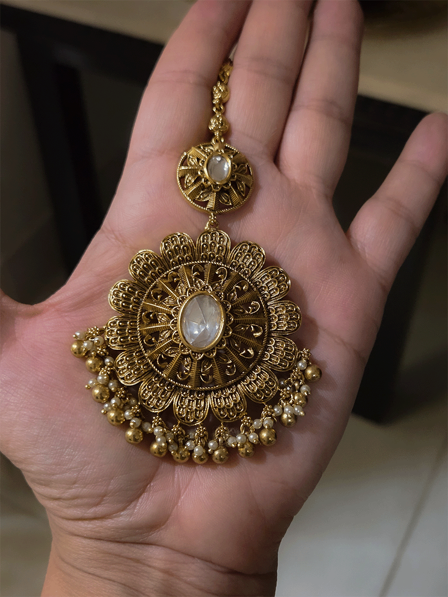 V shaped tear shaped kundan intricately carved set with flower design hanging tukdi in center