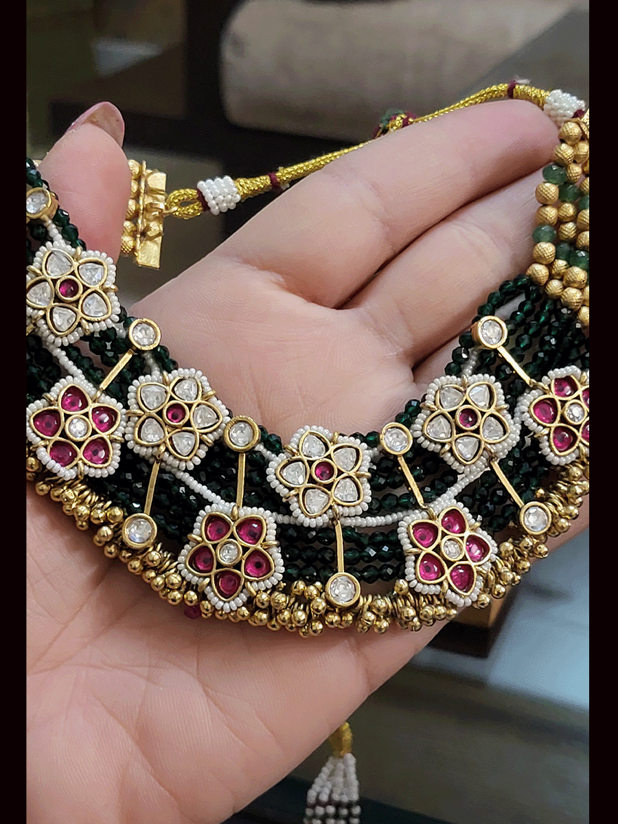 Green strings kundan and ruby pirohi work flowers broad necklace set with golden ghunghru detailing