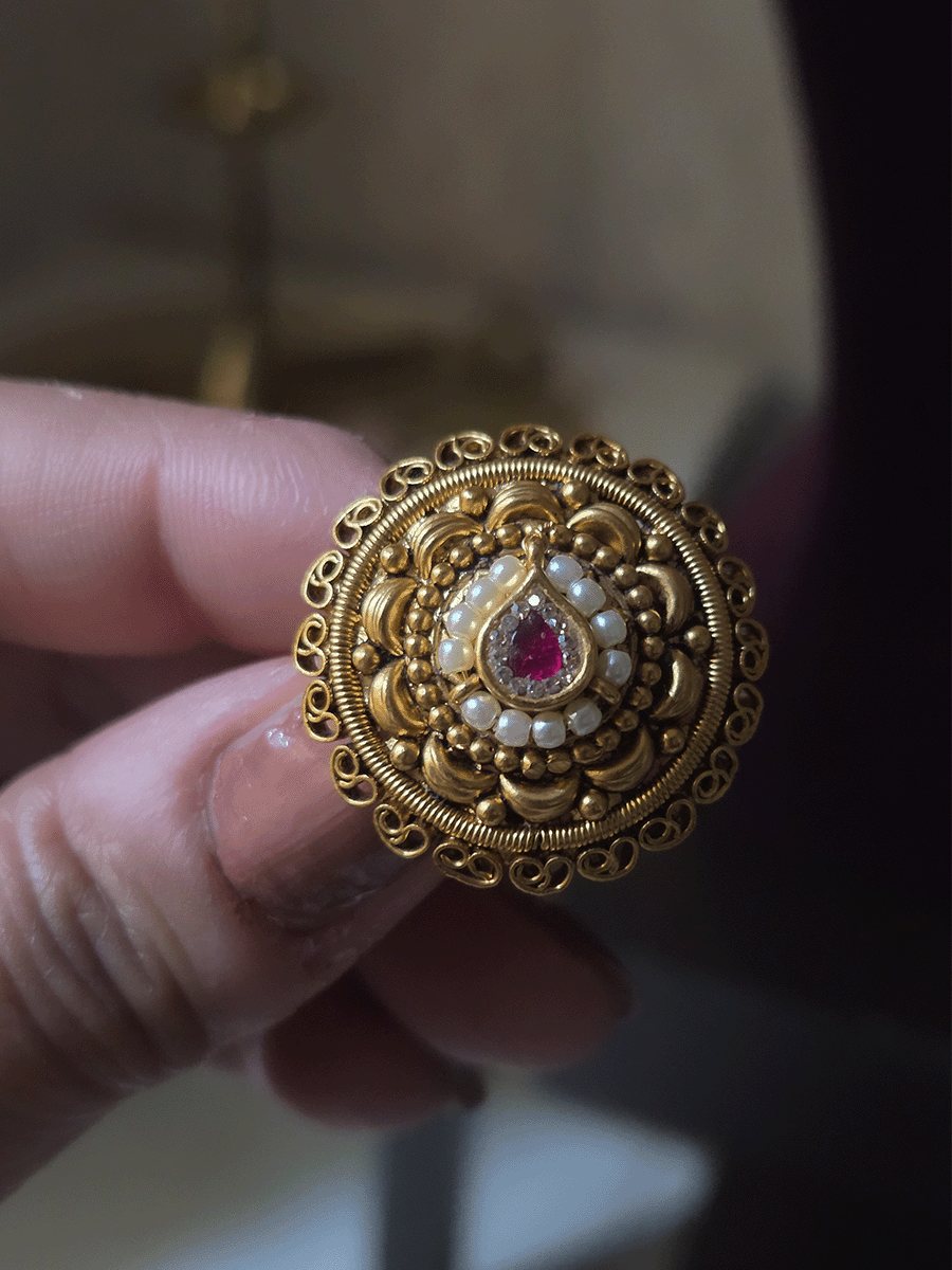 Circular adjustable ring with tear drop ruby stone center