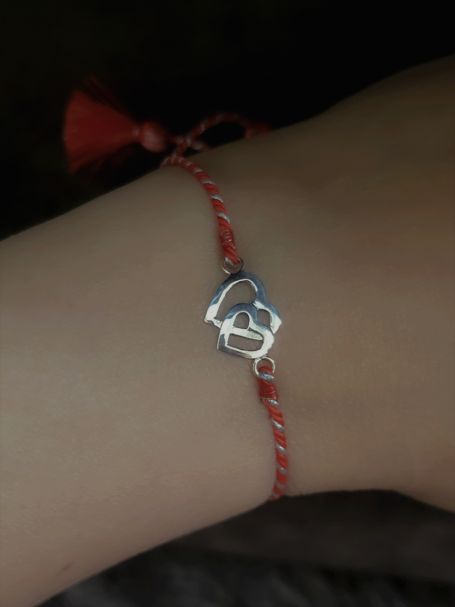 Sterling silver heart on heart pull on red thread rakhi