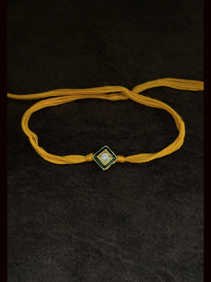 Square shaped brown stone with green enamel outline bhai rakhi in yellow thread