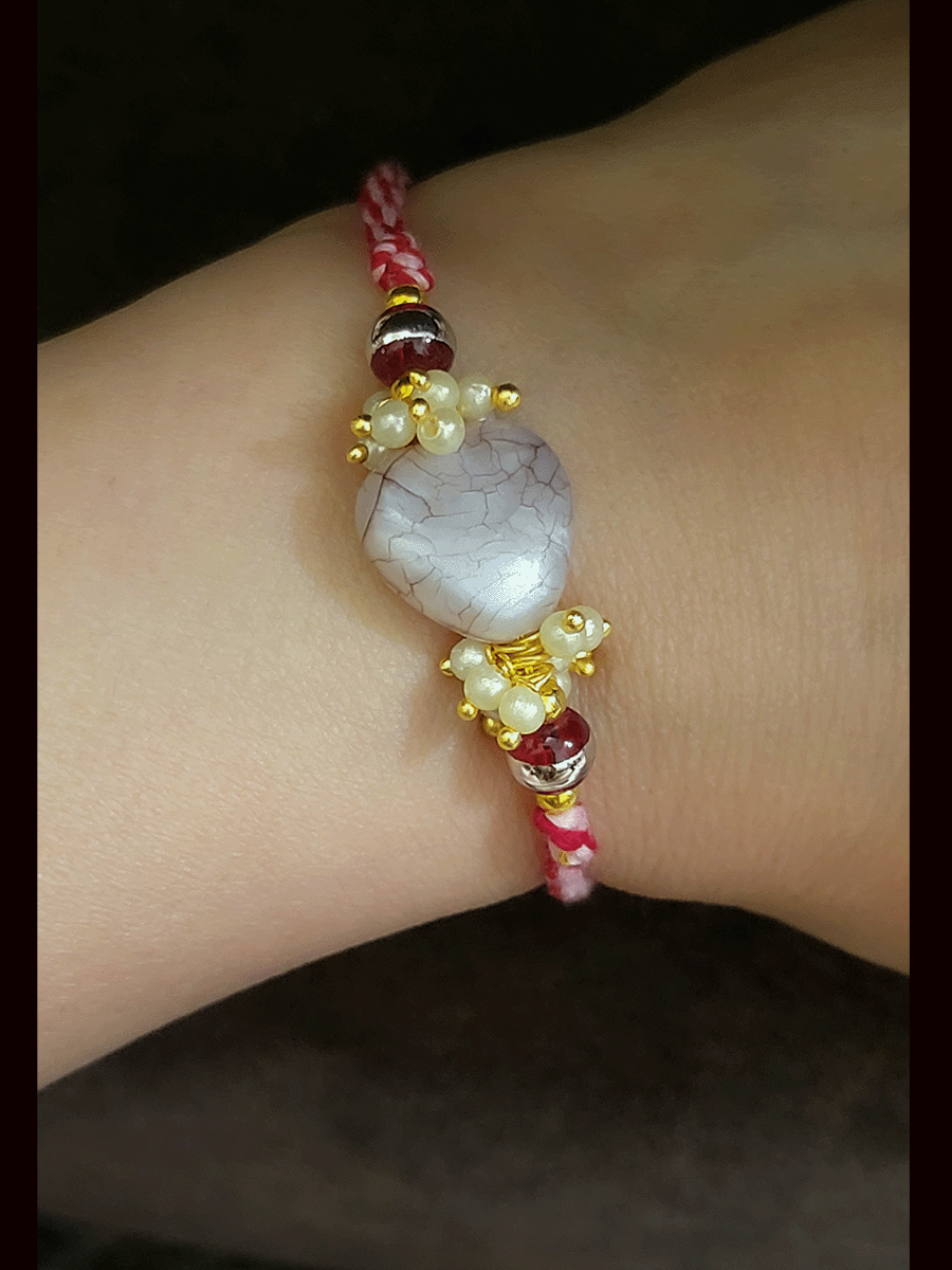 Textured white stone with side pearly cluster beads bhai rakhi