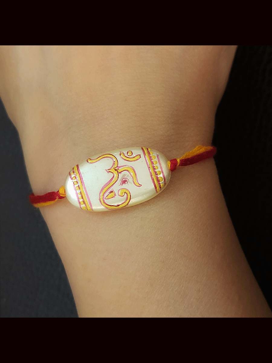 White oval bead with hand painted om and ganpati design