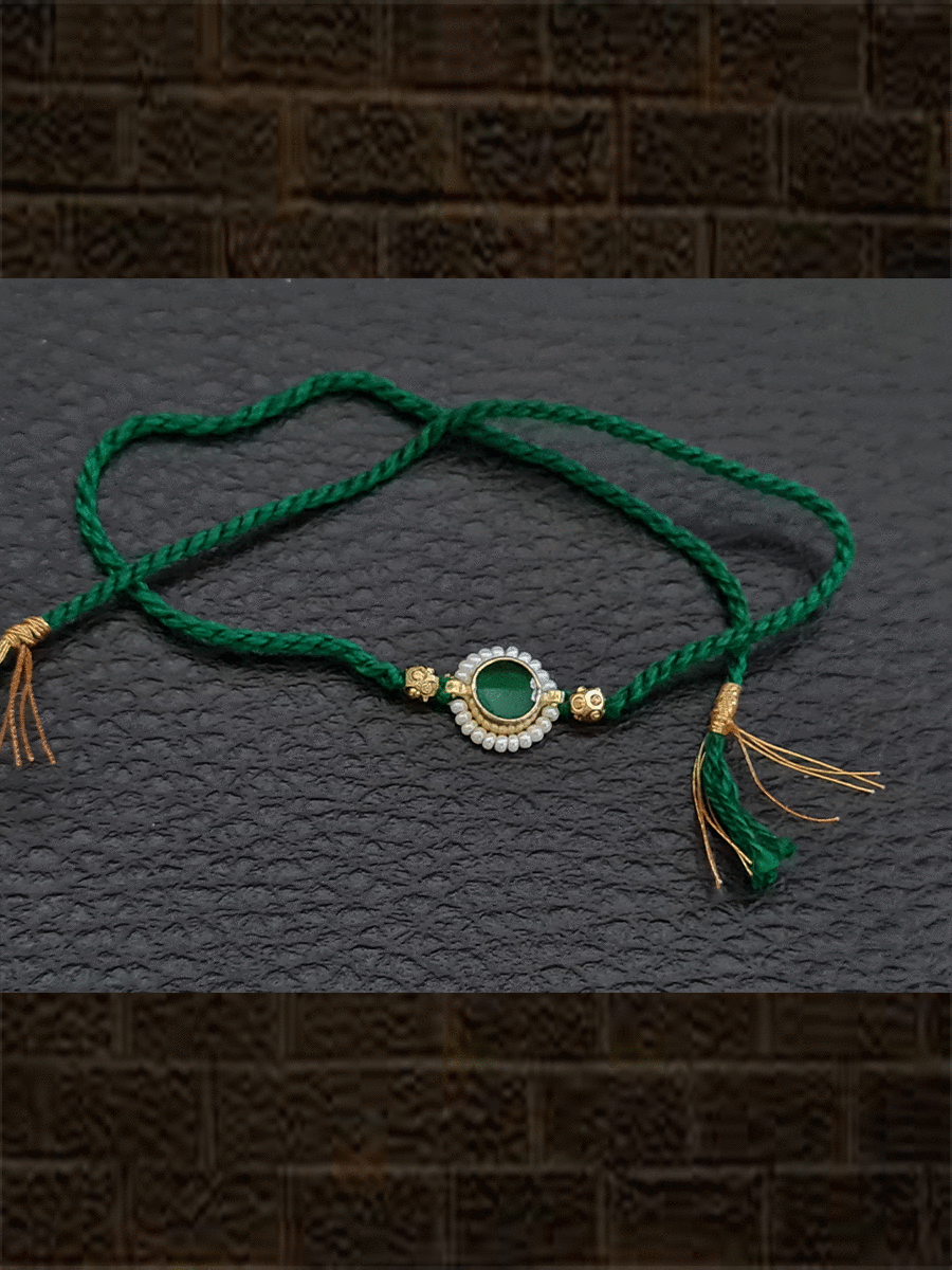 Green round stone pirohi work rakhi with two gold beads on sides - Odara Jewellery
