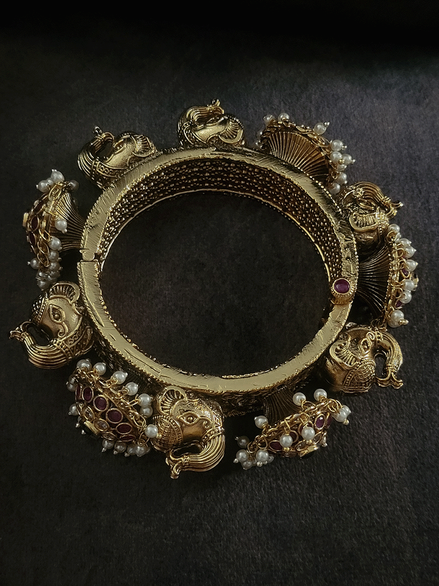 Ruby,polki and green stones pacheli style kadas with elephant design