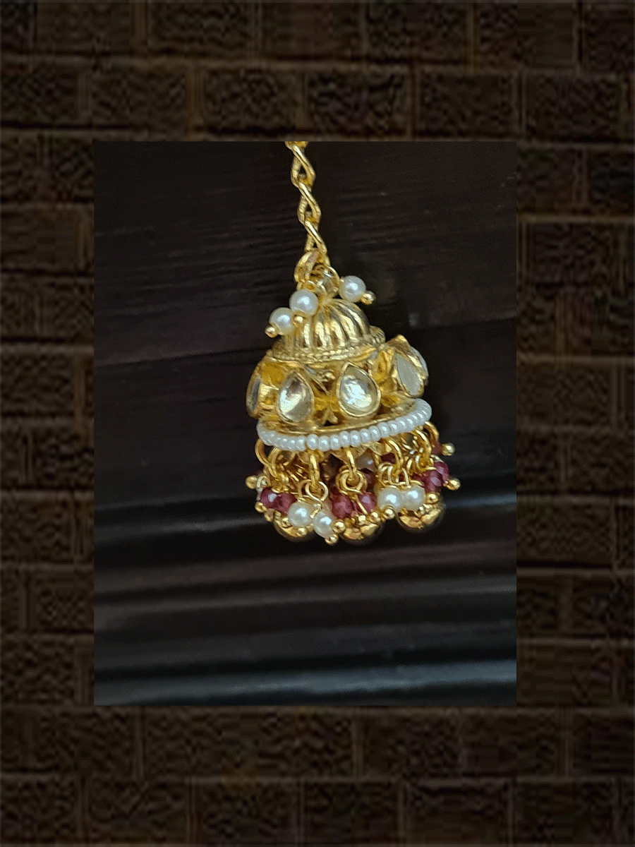 Rectangular kundan tukdi with multiple cheed strings bracelet rakhi with ruby and green bead detailing and hanging kundan jhoomki - Odara Jewellery