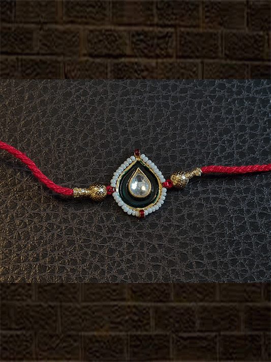 Green enamel leaf design rakhi with pirohi in red thread - Odara Jewellery