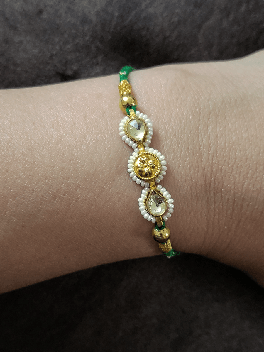 Two kundan leaf with pirohi work and antique tukdi rakhi in green thread - Odara Jewellery