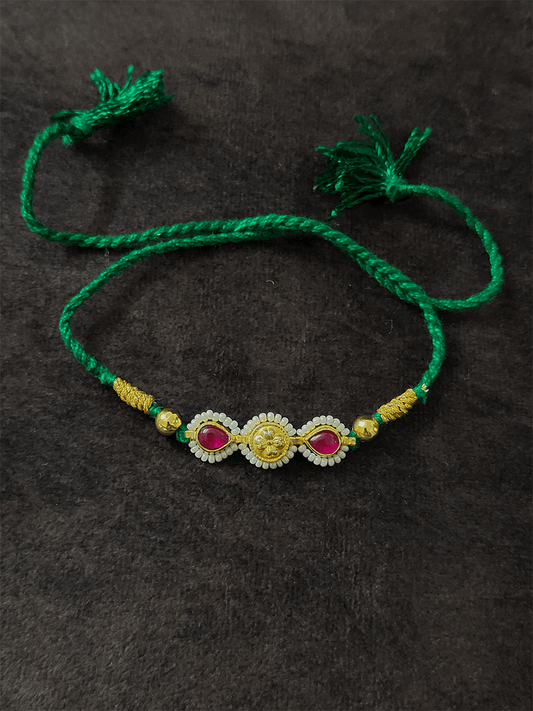 Two ruby leaf stones with pirohi work and antique tukdi rakhi in green thread - Odara Jewellery