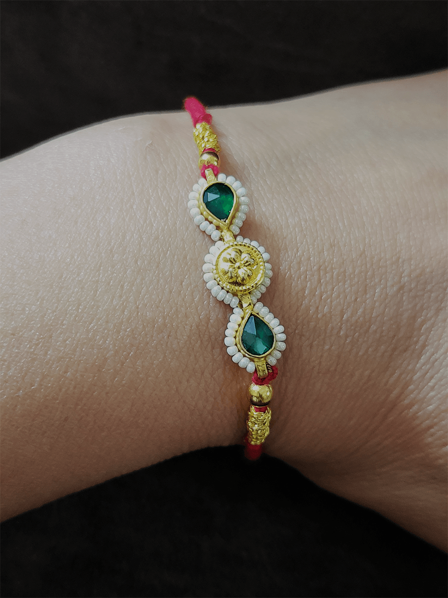Two green leaf stones with pirohi work and antique tukdi rakhi in red thread - Odara Jewellery