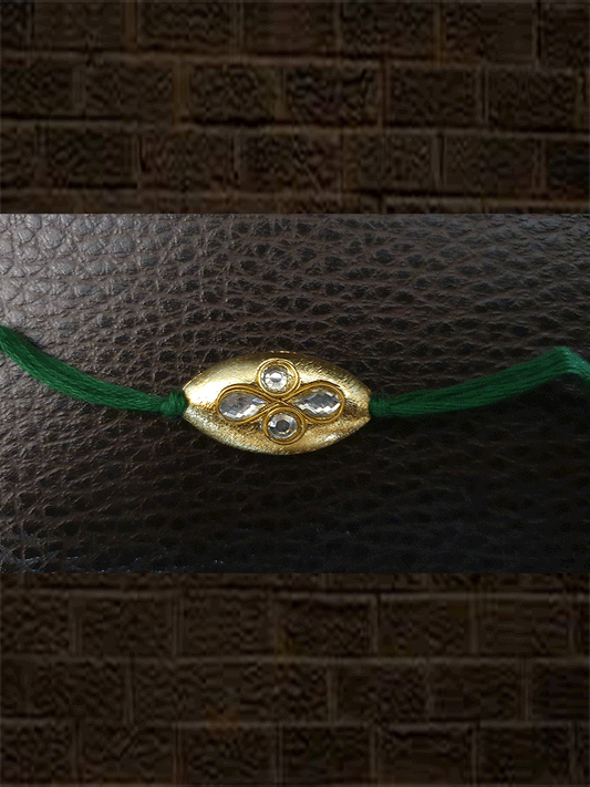 Oval gold bead green thread kundan rakhi - Odara Jewellery