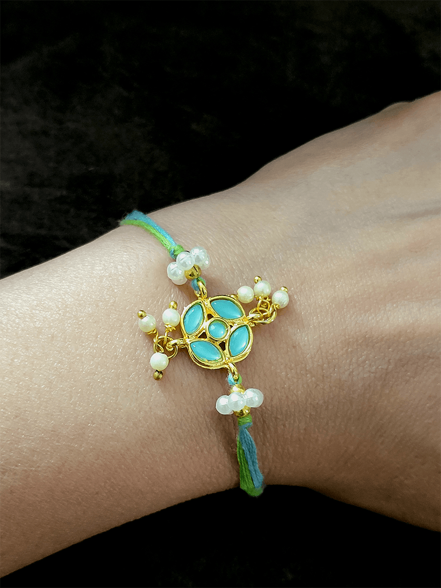 Stone studded flower shaped rakhi with pearly hangings - Odara Jewellery