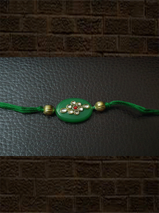 Oval green stone rakhi with kundan and red stone - Odara Jewellery