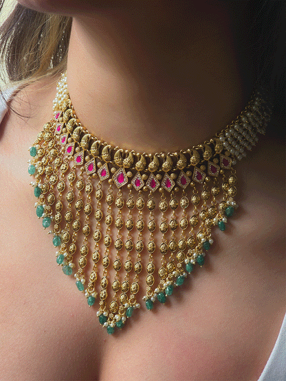 Golden tukdi tassels with green bead drops and paisley design top ruby stones set