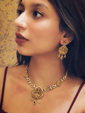 Laxmiji center piece with AD and ruby stone drop set with paisley design polki, ruby and green stones side string