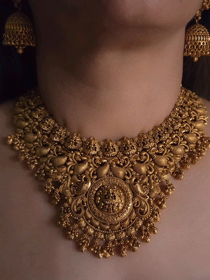 Laxmiji motif in circular design center and on neckline of peacock design broad set with ghunghru hangings
