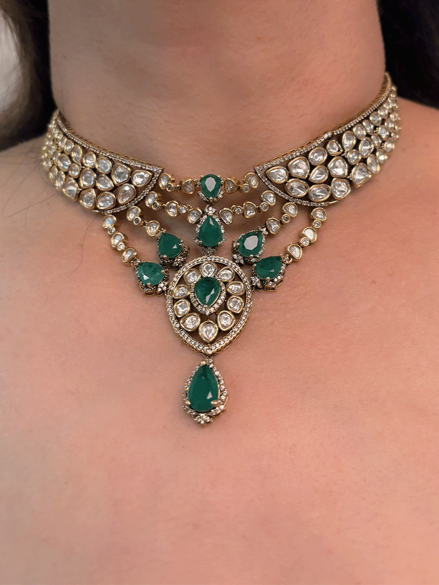 Moissanite set with connecting moissanite tukdies with green tear drop stones set