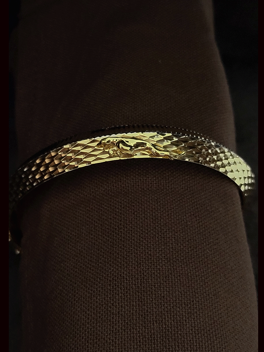 Lines on one side and Jaguar motif wavy design  on other side of rhodium and gold plated kada