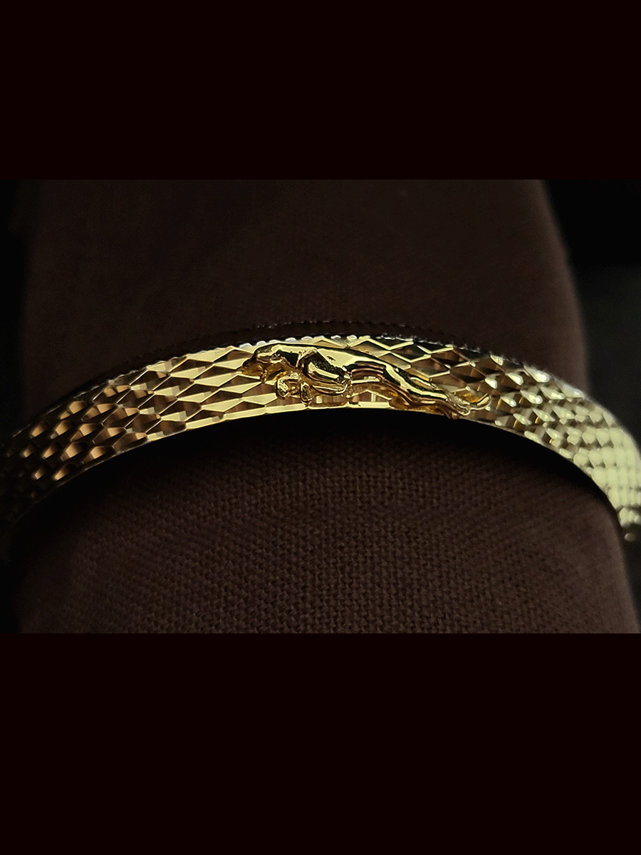 Lines on one side and Jaguar motif wavy design  on other side of rhodium and gold plated kada