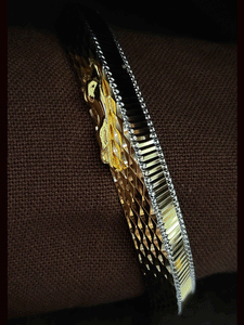 Lines on one side and Jaguar motif wavy design  on other side of rhodium and gold plated kada